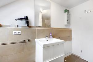 un bagno con lavandino e specchio di Ferienwohnung am Bach a Unterkirnach Altre 17 foto