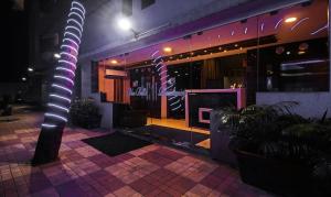 a building with a pole in front of it at night at Luna Spaces -Bella Vista Near Mumbai Airport IIT Powai in Mumbai