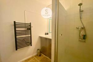 a bathroom with a shower and a sink at Marmandin Arles centre in Arles +17 photos