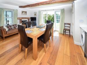 a dining room with a table and chairs at Hollin Bank Barn in Coniston