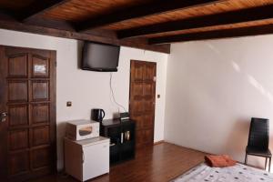 a room with a tv on the wall and a door at HILTIN City centr Ostrava in Ostrava