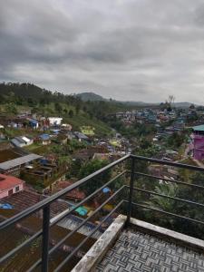 a view of a city from a balcony at Vanilla homestay in Vālpārai