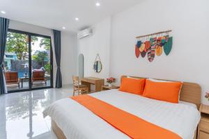a bedroom with a bed with orange pillows at Sunny Beach Villa in Danang +32 photos