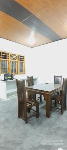 a wooden table and chairs in a room at Freedom Villa in Kamburugamuwa