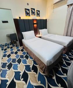 a hotel room with two beds and a carpet at Blue Sky Way Hotel in Dubai