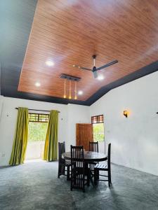 a dining room with a table and chairs and a ceiling at Freedom Villa in Kamburugamuwa