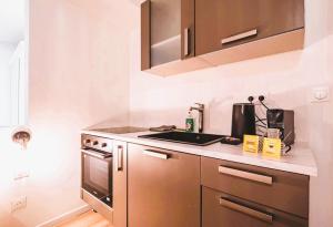 a kitchen with a sink and a stove at Houston - Appartement cosy et original in Reims