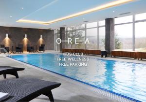a large swimming pool in a hotel lobby at OREA Resort Santon Brno in Brno