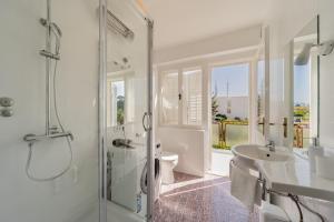 a bathroom with a shower and a sink and a toilet at Villa Croatia with studio apartment with jacuzzi in Trogir +19 photos