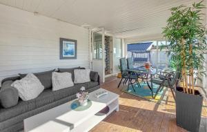 a living room with a couch and a table at 3 Bedroom Beautiful Home In Falkenberg in Stora Hansagård