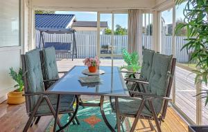 a glass table and chairs on a screened porch at 3 Bedroom Beautiful Home In Falkenberg in Stora Hansagård +17 photos