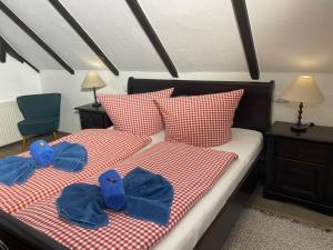a bedroom with two beds with blue slippers on them at Landhaus 3 Stettinerhaff in Dargen