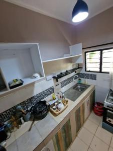a small kitchen with a sink and a stove at Diani Beach Walk in Diani Beach
