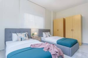 two beds sitting next to each other in a bedroom at Kali - Charming 2-BR Apt & Balcony in Antelias in Anţilyās
