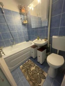 a bathroom with a toilet and a sink and a tub and a toilet at Sky KATERINNA in Brăila +29 photos