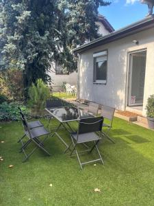 a group of chairs and a table in a yard at Origo II in Debrecen