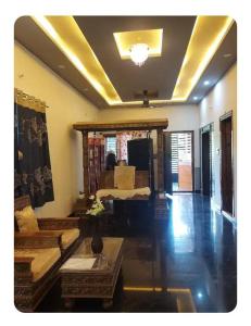 a living room with a bed and a couch at Friendly homestay in Mysore