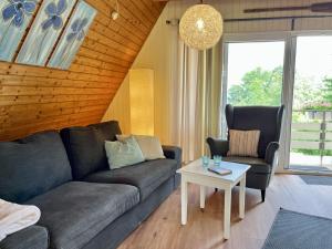a living room with a couch and two chairs and a table at Holiday Home Ferienhäusle Nina by Interhome in Wilhelmsdorf