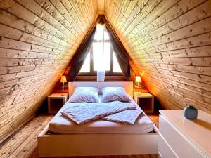 a bed in a room with a wooden wall at Holiday Home Ferienhäusle Nina by Interhome in Wilhelmsdorf