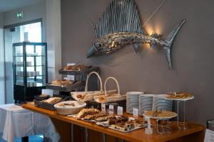 a buffet with bread and pastries on a table at Hotel Europa in Quiberon