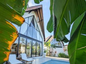 an external view of a house with a swimming pool at Shivo Paje Villas in Paje