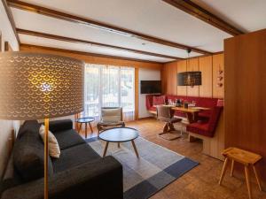 a living room with a couch and a table at Apartment Opale 4 by Interhome in Villars-sur-Ollon
