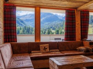 a living room with a couch and a large window at Apartment Rosablanche D Attique by Interhome in Siviez +17 photos