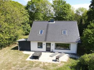 an aerial view of a white house with two benches at Holiday Home Rosa - 300m from the sea by Interhome in Aabenraa
