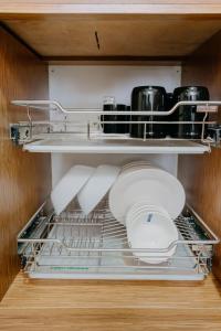 a shelf in a kitchen with dishes and a appliance at NEW Comfy 1BR Cebu IT Park Location in Cebu City