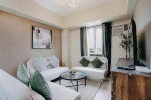 a living room with a couch and a tv at NEW Comfy 1BR Cebu IT Park Location in Cebu City