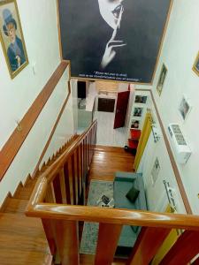a staircase with a large painting on the wall at La trinité in Brazzaville