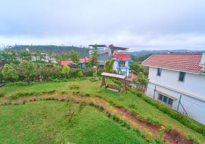 an aerial view of a yard with a house at Pine Forest View Ooty by VOYE HOMES in Ooty