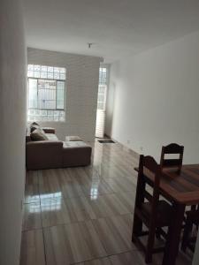 a living room with a couch and a table at Casa inteira próx ao Hangar COP30 - 3km in Belém +9 photos