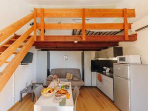 a kitchen and a living room with a loft bed at Apartment Le Télémaque 2 pièces Mezzanine by Interhome in Conca