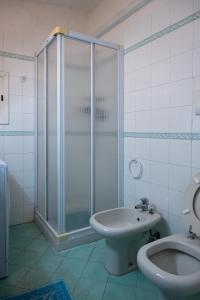 a bathroom with a shower and a sink and a toilet at Ventus Auster in Olbia +13 photos