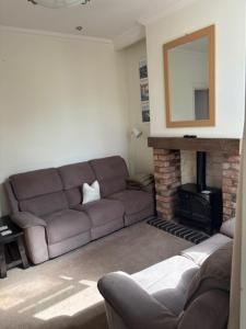 a living room with a couch and a fireplace at Holiday Home in Kidderminster in Kidderminster