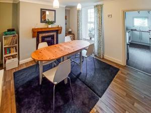 a dining room with a wooden table and chairs at Rockhopper Cottage in Brixham