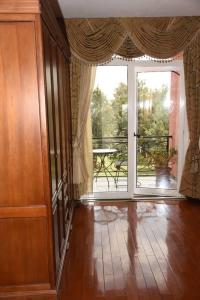 a living room with a large window and a balcony at Diplomat Furnished Apartments in Addis Ababa