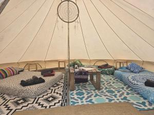 a tent with two beds and a table in a room at Coastal Glamp at Bellarine Estate winery in Bellarine