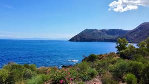a view of a large body of water with mountains at JERA Holiday Collection VULCANO TRE - Sea View in Vulcano