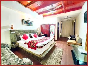 a hotel room with two beds and a couch at HOTEL THE MOON - Near Mall Road & Naini Lake View - LIFT -Free Parking -Restaurant -Wi-Fi Available- Ambience with Valley- A Top Rated Hotel IN Nainital in Nainital