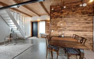 a dining room with a wooden wall at 1 Bedroom Beautiful Apartment In Vallåkra in Ekeby