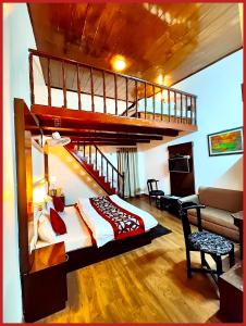 a bedroom with a loft bed and a staircase at HOTEL THE MOON - Near Mall Road & Naini Lake View - LIFT -Free Parking -Restaurant -Wi-Fi Available- Ambience with Valley- A Top Rated Hotel IN Nainital in Nainital