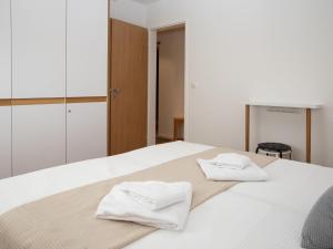 a bedroom with a bed with two towels on it at Apartment La Siala Apt-19 by Interhome in Falera