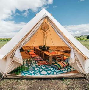 a white tent with a table in it at Coastal Glamp at Bellarine Estate winery in Bellarine