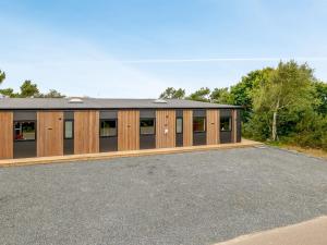an image of a building with a parking lot at Holiday Home Øthger - 1-3km from the sea by Interhome in Ringkøbing +29 photos