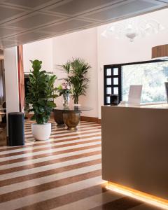 an office with potted plants and a desk at Hotel Giada Viale del Sole in Vicenza