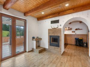 a living room with a fireplace and a wooden ceiling at Chalet Horalka by Interhome in Železná Ruda