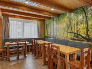 a dining room with tables and chairs and a mural at Chalet Horalka by Interhome in Železná Ruda +52 photos