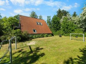 a house with an orange roof and a soccer field at Holiday Home Sunna - 1km from the sea by Interhome in Humble +21 photos